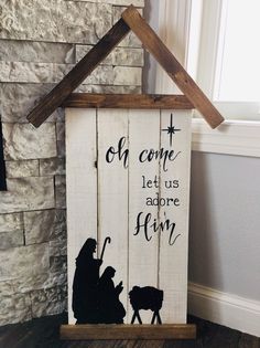 a wooden sign that says, oh come let us adore him with the nativity scene