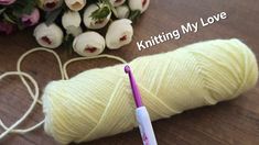 a skein of yarn next to flowers and a knitting needle with the words knitting my love written on it