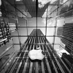 an iphone case with the apple logo in front of a tall building's windows