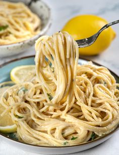 a fork full of pasta with lemon and parsley