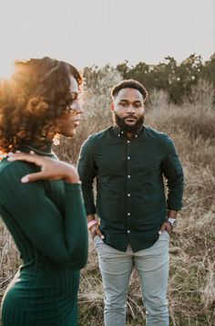 a man standing next to a woman in a field