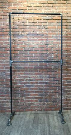 a black metal frame against a brick wall