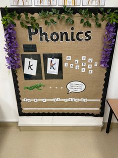 a bulletin board is decorated with purple flowers and green leaves, along with the words phonics