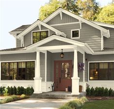 the front view of a house with blue door and windows on both sides of it