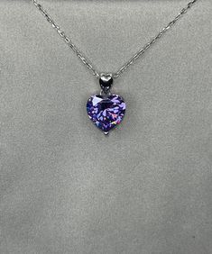 "A beautiful purple shaded necklace that is sure to get lots of attention. Makes a great gift, arrives in a wrapped gift box. 5 Ct. Heart-Cut Moissanite Diamond Purple Sapphire Bridal Necklace 925 Sterling Silver Chain Size : 18 \" (45.7 cm) including the clasp Pendant Size : 1.2 cm (5 Carat) Main Stone Color : Purple Main Stone: Moissanite Topaz Main Stone Shape : Heart Cut Metal : Real Solid 925 Sterling Silver Hallmark : 925 Stones Setting : Prong Finish : Fine Polished Guaranteed High Qualit Purple Heart Cut Sterling Silver Necklace, Purple Heart-cut Sterling Silver Necklace, Sterling Silver Purple Heart Pendant Necklace, Purple Sterling Silver Heart Cut Necklace, Purple Sterling Silver Heart Pendant Necklace, Purple Sterling Silver Necklaces For Valentine's Day, Purple Cubic Zirconia Jewelry For Valentine's Day, Formal Heart Cut Birthstone Necklace, Purple Heart Cut Necklace For Valentine's Day