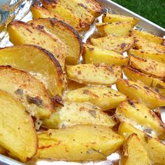 some potatoes are sitting in a pan on the grass and ready to be cooked for dinner