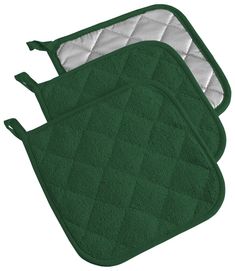 two green oven mitts sitting next to each other