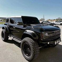 a large black truck parked in a parking lot