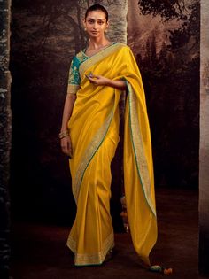 The Lovely Yellow Banglory Silk Party Wear Saree With Blouse is a stunning piece that will surely make heads turn at any event. Made from high-quality Banglory silk fabric, this saree exudes beauty and richness. It is adorned with fabulous embroidery on the border and features beautiful pattern work throughout.
The saree comes in a gorgeous yellow color, adding a touch of vibrancy and elegance to your ensemble. It is 5.50 meters long, providing ample material to drape and style in various ways. Yellow Saree With Contrast Blouse, Yellow Paithani Saree, Yellow Paithani, Yellow Sarees, Wedding Sarees Online, Fancy Fabric, Organza Silk Saree, Yellow Saree, Utsav Fashion