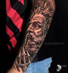 a man's arm with a portrait of jesus on it and an arrow in the middle