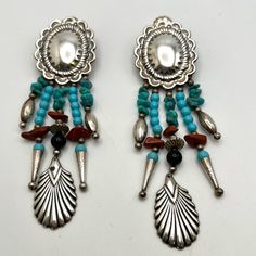 Kabana Sterling Turquoise Fringed Concho Earrings 3.75" H Statement Earrings 1.5" Detailed Sterling Concho Oval 5 Dangles With Turquoise And Cinnabar Chips Sleeping Beauty Turquoise Rounds Single Onyx Round Fun Sterling Bolo Tips And Other Sterling Accents Original Sterling Backs Gently Polished Leaving Some Tarnish Good Vintage Condition Elegant Blue Jewelry With Concho Detail, Elegant Blue Concho Jewelry, Blue Concho Dangle Earrings, Kabana Jewelry, Southwestern Blue Concho Jewelry, Concho Earrings, Turquoise Nickel-free Western Earrings, Western Style Nickel-free Turquoise Earrings, Nickel-free Blue Southwestern Earrings