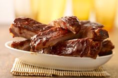 some ribs are sitting on a white plate