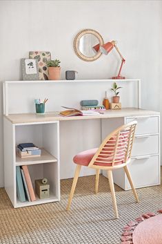 a room with a desk, chair and bookshelf next to a window in it