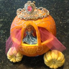 an orange pumpkin with a princess in it