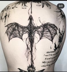 the back of a woman's body with tattoos on it and writing all over it