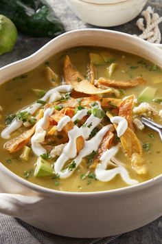 a white bowl filled with soup sitting on top of a table