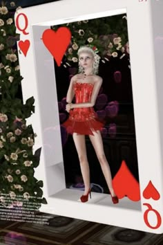 a woman in a red dress and high heeled shoes standing next to a playing card