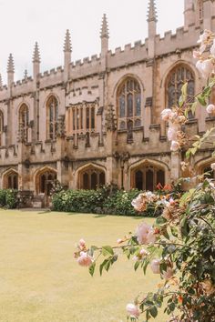 an old building with flowers in front of it