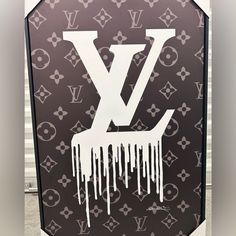 a louis vuitton sign with white paint dripping from the letter v on it