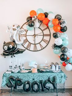 a table with balloons and decorations for a new year's eve party on it