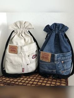 two denim bags sitting on top of a table