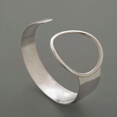 Hammered Asymmetric Ring Sterling Silver Cuff Bracelet Modern Wide Band Bangle With Polished Finish, Modern Hand Forged Bangle Jewelry, Modern Hand Forged Bangle, Modern Hammered Cuff Bangle, Modern Sterling Silver Open Cuff Bangle, Modern Adjustable Cuff Bracelet With Open Band, Modern Hammered Cuff Jewelry, Modern Silver Open Ring Bracelet, Modern Adjustable Open Band Cuff Bracelet