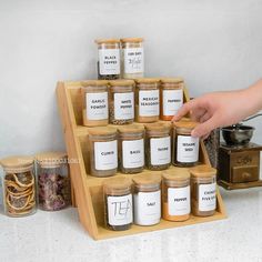 a wooden spice rack filled with jars and spices