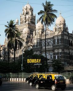 taxi cabs are parked in front of a large building that has a bomb bay sign on it