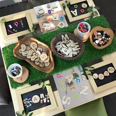 a table topped with lots of different types of letters and numbers on top of green grass