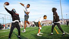 three men are playing football on the field