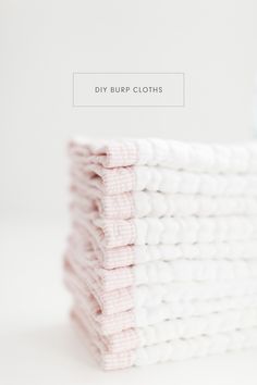 a stack of pink and white crocheted cloths sitting on top of each other