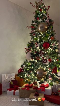 a decorated christmas tree with presents under it