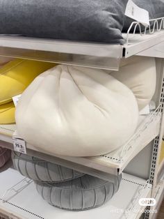 the shelves are filled with pillows and other items