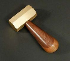 a wooden mallet on a black surface