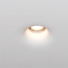 a close up of a light on a white wall in a room with no people