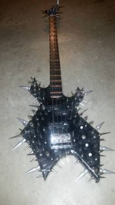 an electric guitar with spiked spikes on it