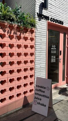 a sign in front of a building that says cookie coffee and smoothie juice is on the sidewalk