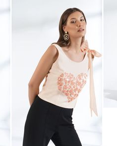 ▶ ABOUT THE TOP: This ivory crepe top is a statement of style. Hand embroidered with sequin in shape of small hearts and a big statement organza bow. Perfect for a day out at the office or a casual brunch with your friends. Made from 100% pure crepe fabric, the top has a regular fit and we offer it in plus sizes up to 5XL. ▶ ITEM DETAILS: * Top made with pure crepe * The model is 5'7 tall and wearing size M. * Handmade item, crafted to perfection. * The length of the top is 19 inches ▶ FABRIC: * Fitted Feminine Embroidered Top, Elegant Embellished Cotton Tops, Sleeveless Cotton Sequin Top, Chic Fitted Tops With Floral Embroidery, Spring Party Tops With Pearl Embroidery, Spring Evening Top With Pearl Embroidery, Elegant Embroidered Summer Top For Party, Embroidered Sleeveless Evening Blouse, Elegant Embroidered Summer Party Top