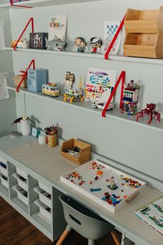 there are many legos on the shelves in this room, including one for children