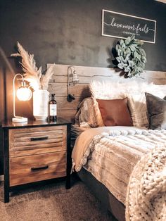 a bed room with a neatly made bed next to a night stand and two lamps