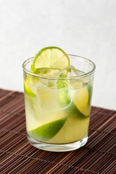 a glass filled with lemonade and lime slices