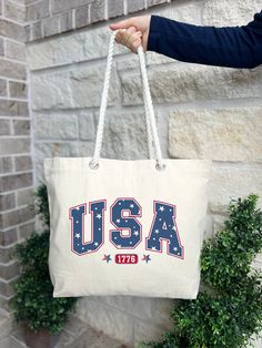 Independence Day Tote Bag, Memorial Day Tote Bag, 4th of July Tote Bag, Patriotic Tote Bag, Gift For Patriot, 4th of July Tote Bag, USA Lover Gift Tote Bag HOW TO ORDER: 1. Please, Check and Review all Photos.  2. Choose Your Quantity as much as you want. 3. Click "Add To Cart". For multiple items go back to the listing and repeat the steps. *DETAILS OF THE BAGS: 25L Tote Bag Measurements - 20"L x 15"H x 5"D 100% cotton , 26" rope handles, inside zippered flap pouch pocket. * PROCESSING & SHIPPING: Processing time is 1-2 days. First Class Shipping is 2-5 business days (after processing time). You can upgrade your shipping on the check out page to UPS Ground and UPS-2 Day Business Services (after processing time). *CARE INSTRUCTION: Do not bleach, do not dry clean, do not iron directly on t Gift Totes, Bag Measurements, Business Services, Rope Handles