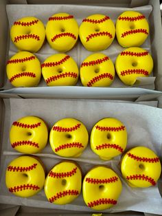 two boxes filled with donuts covered in yellow frosting