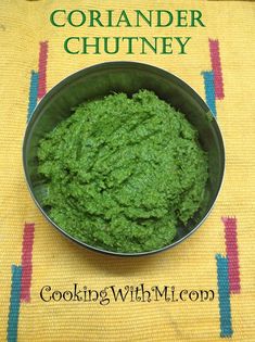 a bowl filled with green food on top of a table