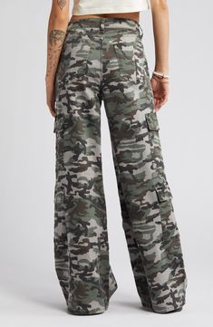 Give in to your style nostalgia and throw it back to Y2K in a pair of wide-leg cargo pants cut from a stretchy cotton blend patterned with classic camo. 32" inseam; 25 1/2" leg opening; 10" front rise; 15" back rise 97% cotton, 3% spandex Machine wash, tumble dry Imported Military Camouflage Jeans With Cargo Pockets, Military Cargo Style Camouflage Jeans, Military Camouflage Cargo Jeans, Camouflage Military Cargo Jeans, Camouflage Wide Leg Cargo Bottoms, Military Style Wide Leg Cotton Cargo Pants, Camouflage Wide Leg Bottoms With Multiple Pockets, Wide Leg Camouflage Bottoms With Multiple Pockets, Camouflage Wide-leg Bottoms With Multiple Pockets