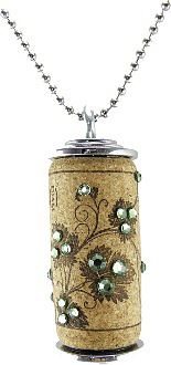 a can with flowers and pearls on it is sitting on a chain that has a ball chain attached to it