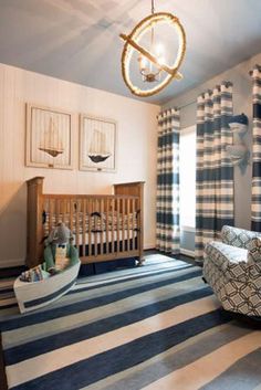 a baby's room with blue and white striped curtains, a rocking chair, and a crib