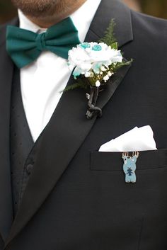 a man in a tuxedo with a boutonniere on his lapel