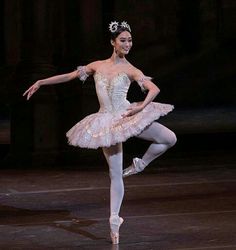 a ballerina in a pink tutu and tiara