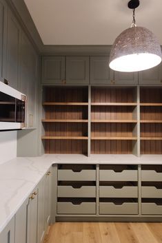 a kitchen with wooden cabinets and white counter tops